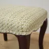 Wooden stool recovered in a woven fabric