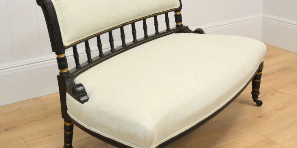 ANTIQUE WOODEN BENCH RE-COVERED IN A CREAM LINEN WITH DOUBLE PIPING