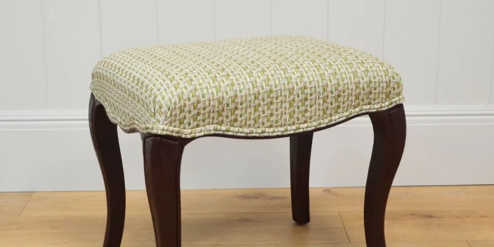 Wooden stool recovered in a woven fabric